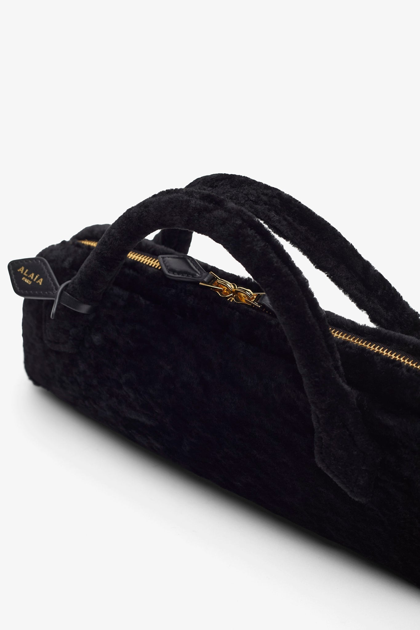 Le Teckel black shearling clutch