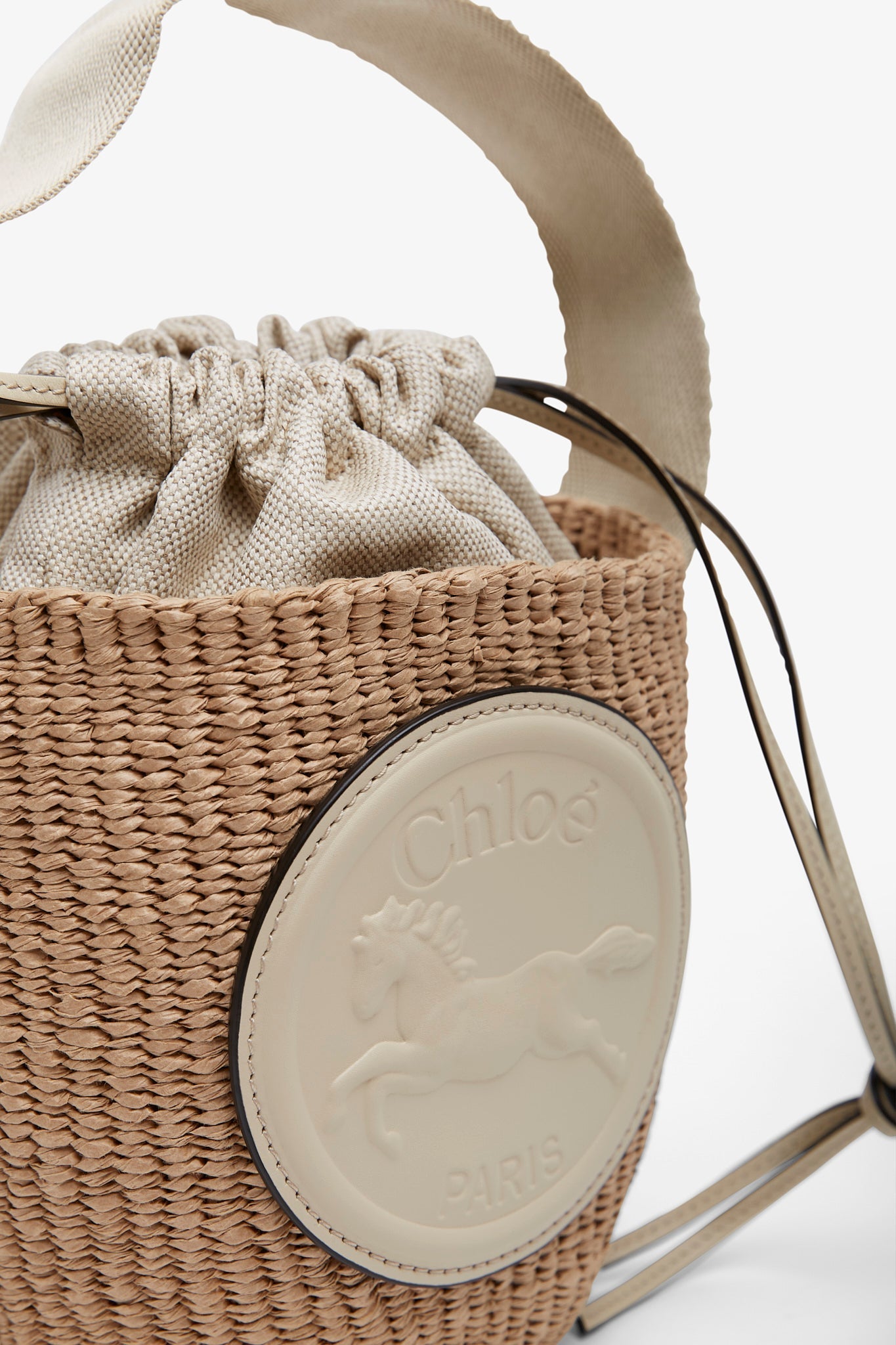 Horse medal ivory raffia bucket bag