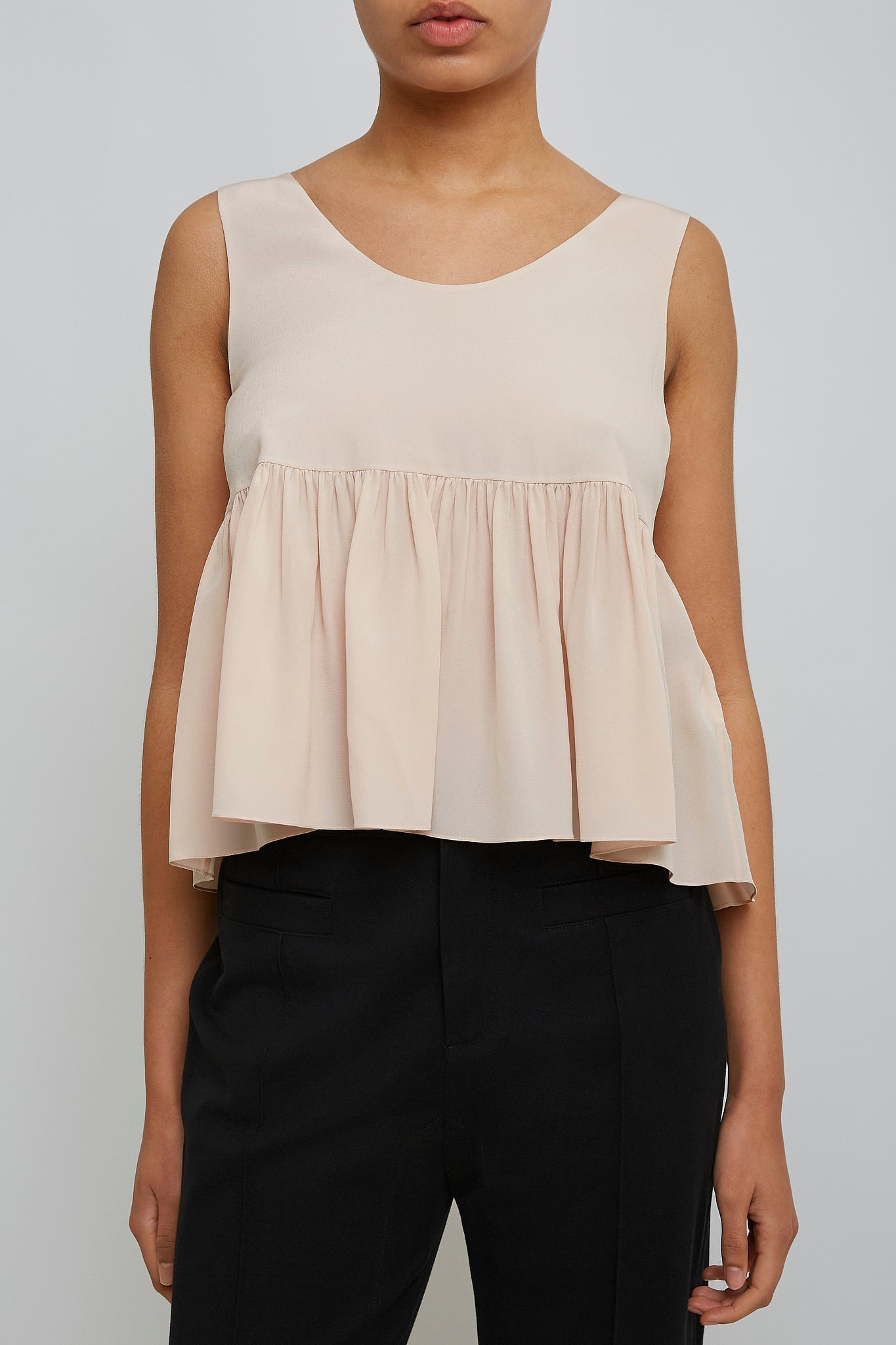 Delicate pink peplum silk top