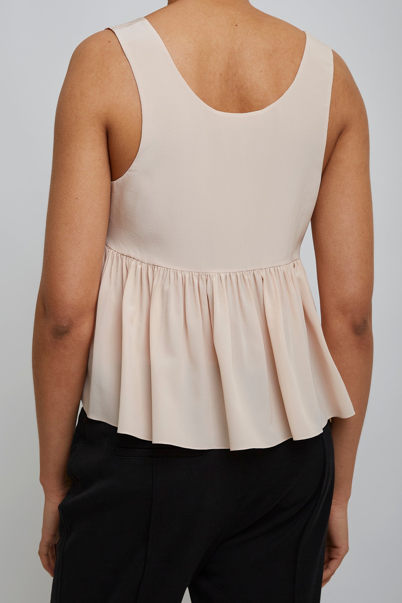 Delicate pink peplum silk top