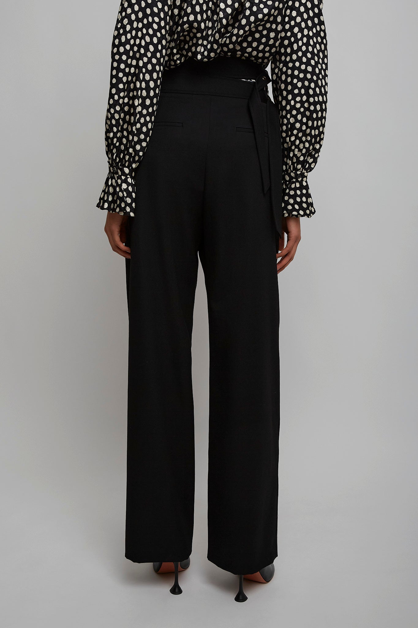 High-waist buckled black trousers