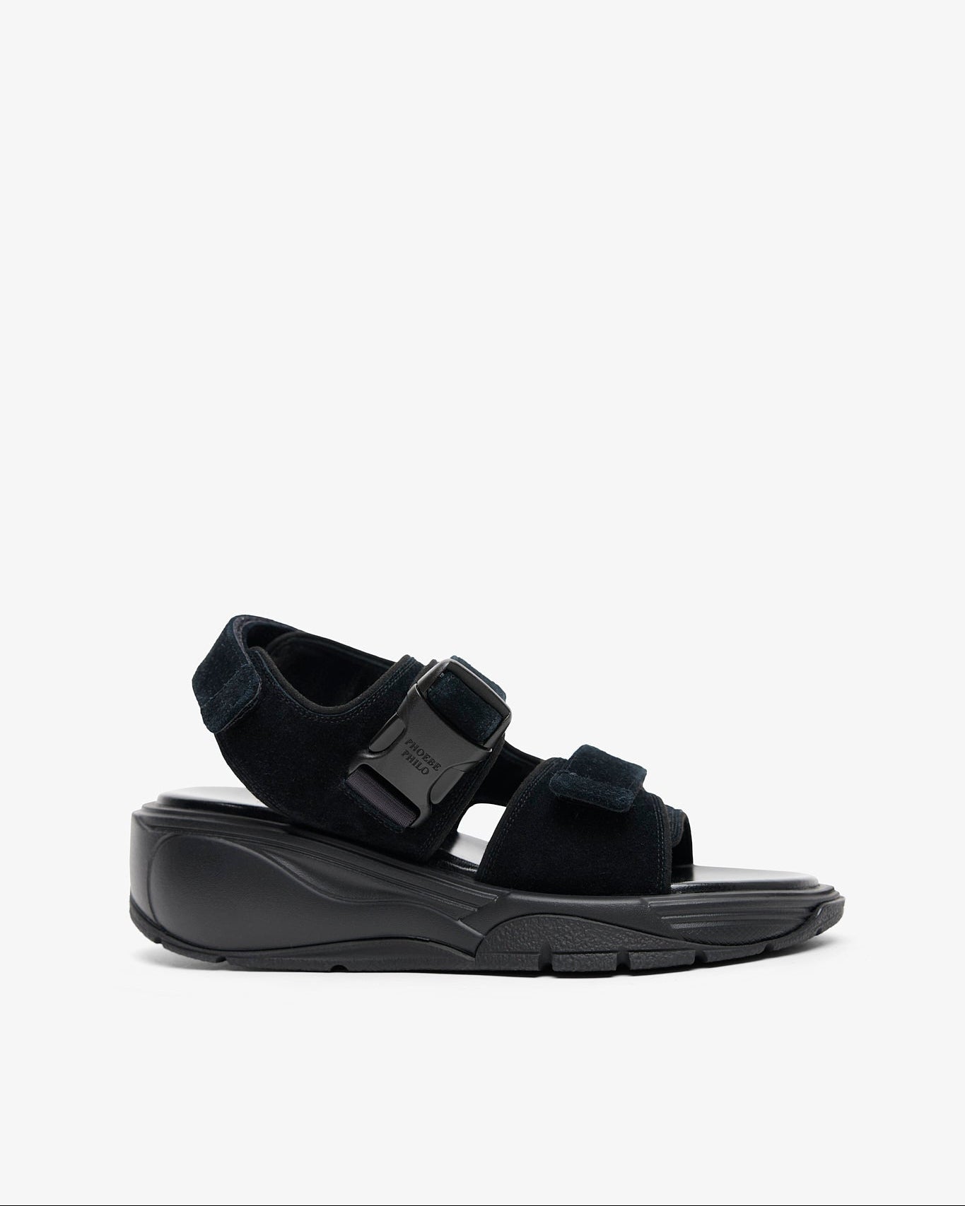 Black sandal with a thick sole on a white background