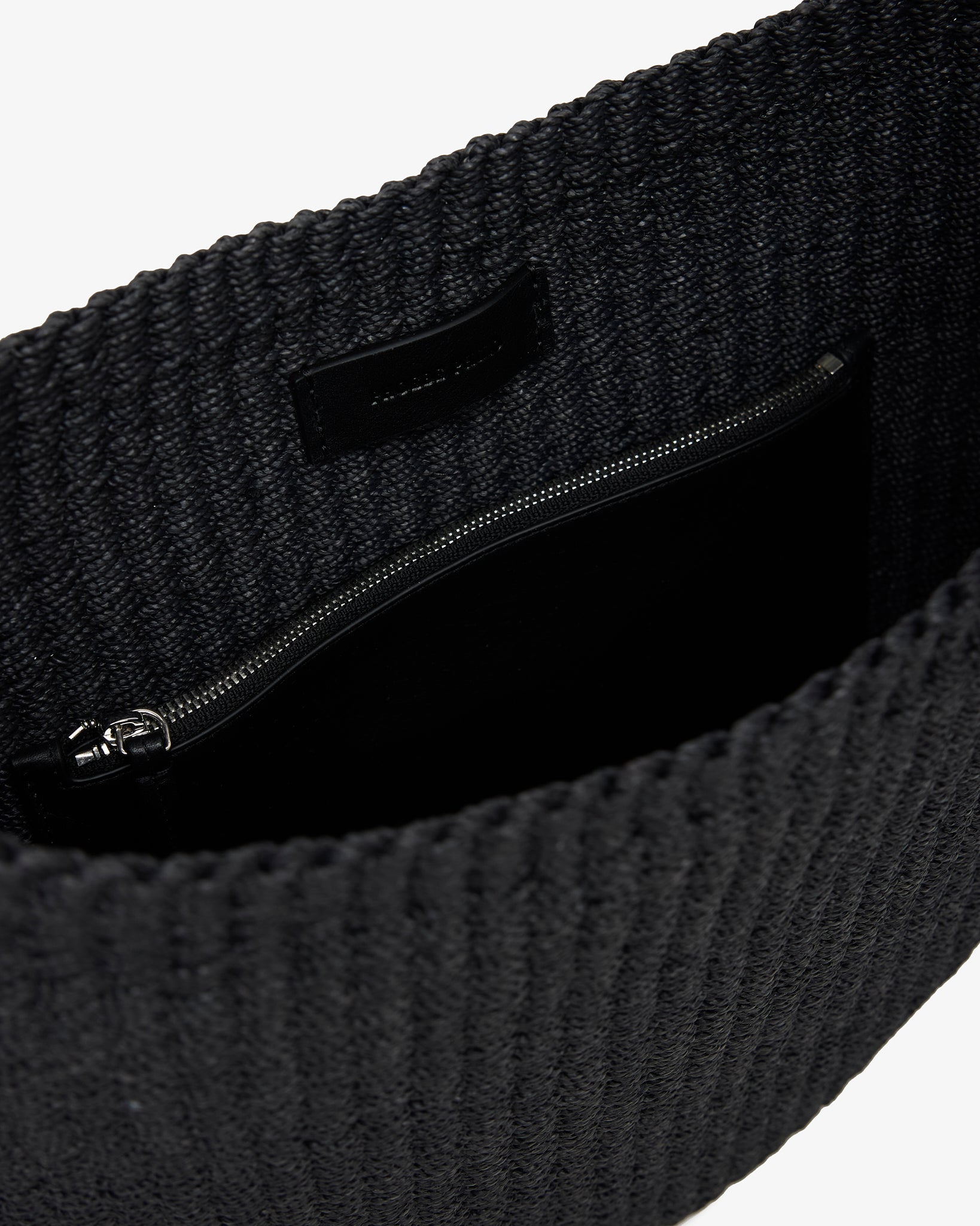 Dark textured fabric with a zipper on a white background