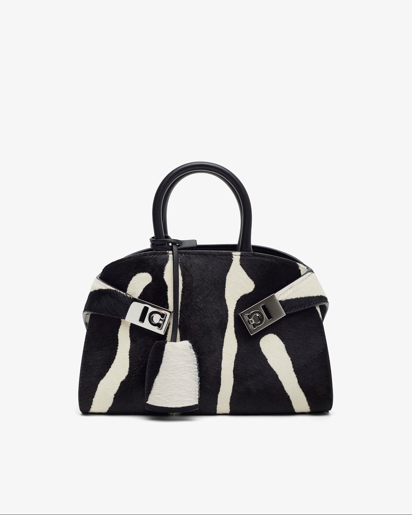Black and white handbag with a distinctive pattern on a white background