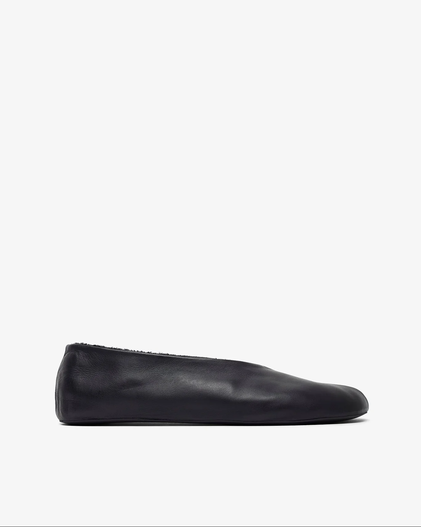 Black slip-on shoe on a white background