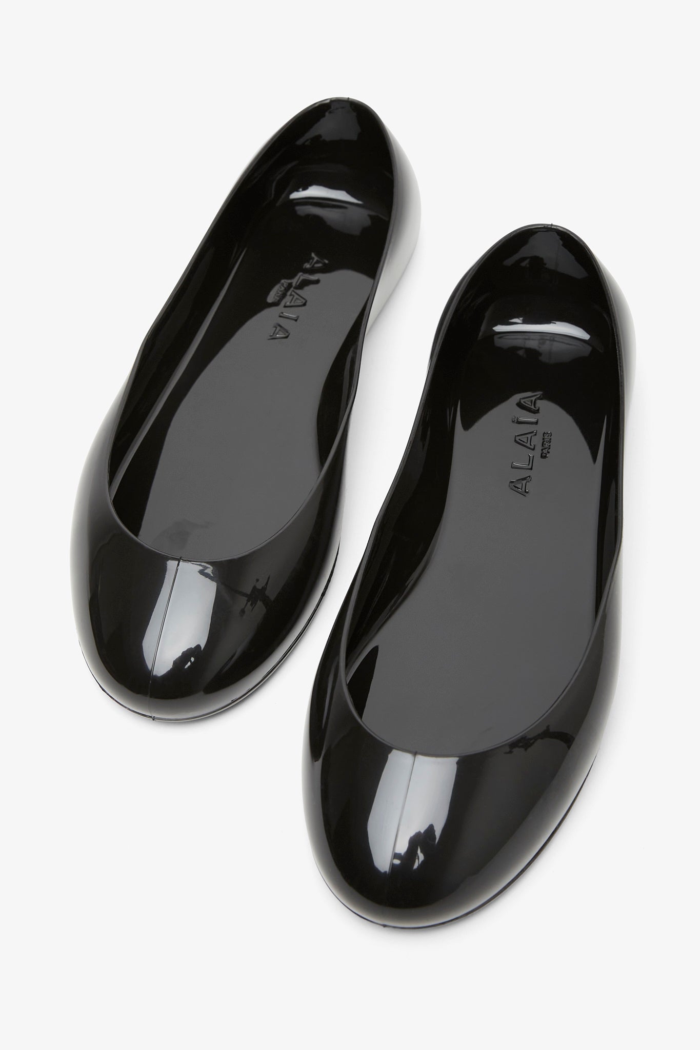 Black rubber ballet flats