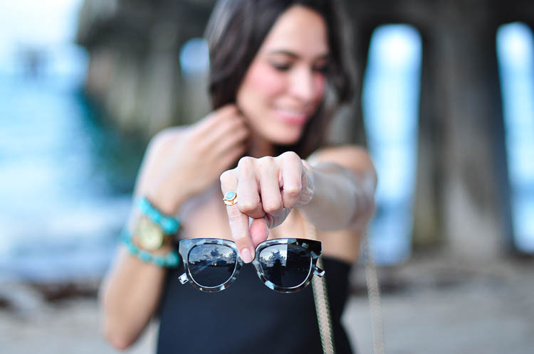 Best Luxury Designers Handbags holding Warby Parker Banks graphic sunglasses 