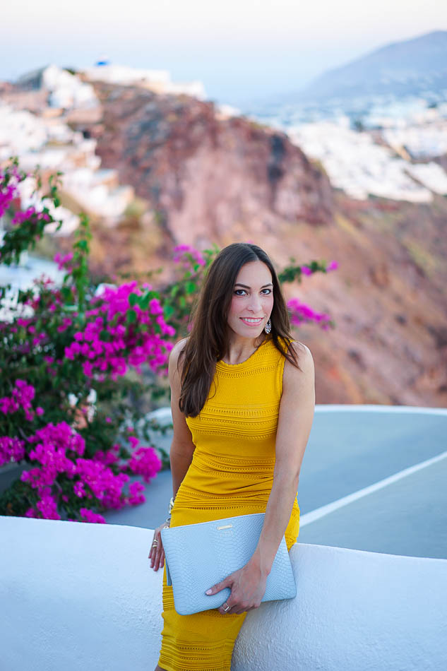 Amanda wearing a striped Torn by Ronny Kobo dress with Vince Camuto sandals, a Gigi New York clutch, Alexis Bittar bangles, and a Park Lane Jewelry ring.
