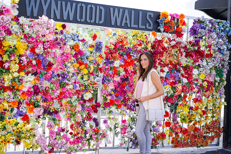Blogger enjoying the bright and cheerful floral wall backdrop,wearing Jcrew Carrie cami