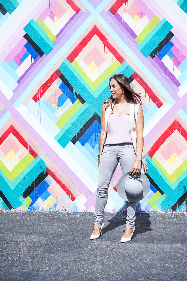 Best Luxury Designers Handbags blogger posing in front of Maya Hayuk’s vibrant geometric mural, wearing Jcrew Carrie cami Topshop Vest