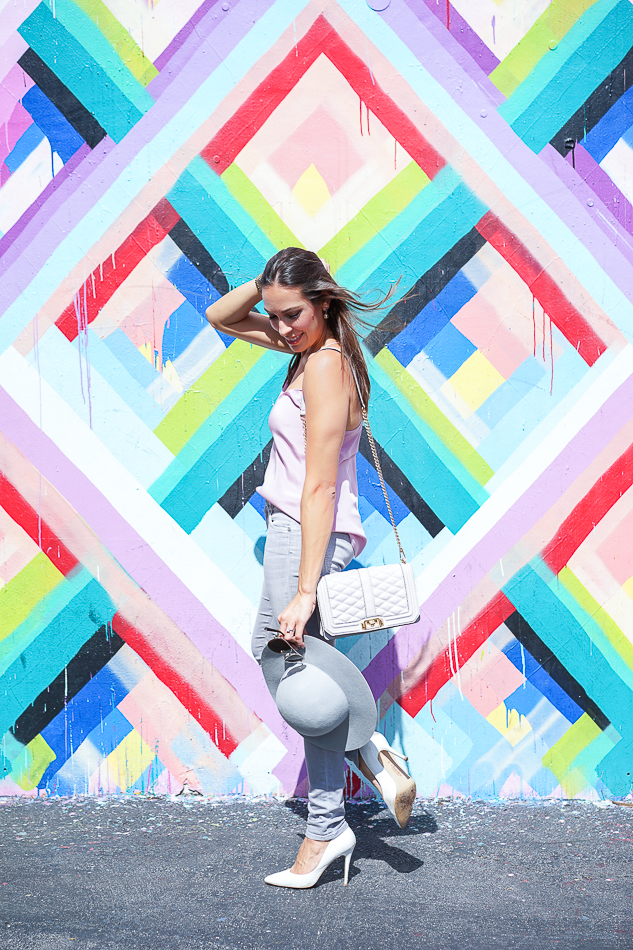 Best Luxury Designers Handbags enjoying the bright, patterned artwork of Maya Hayuk at Wynwood Walls, wearing Jcrew Carrie cami and Rebecca Minkoff Love Crossbody bag side view