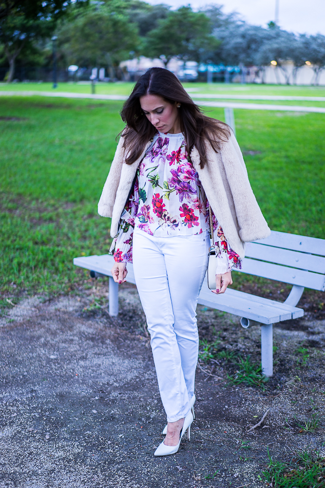 Amanda wearing an Intermix Alberta Ruffle Floral Blouse styled with a faux fur jacket
