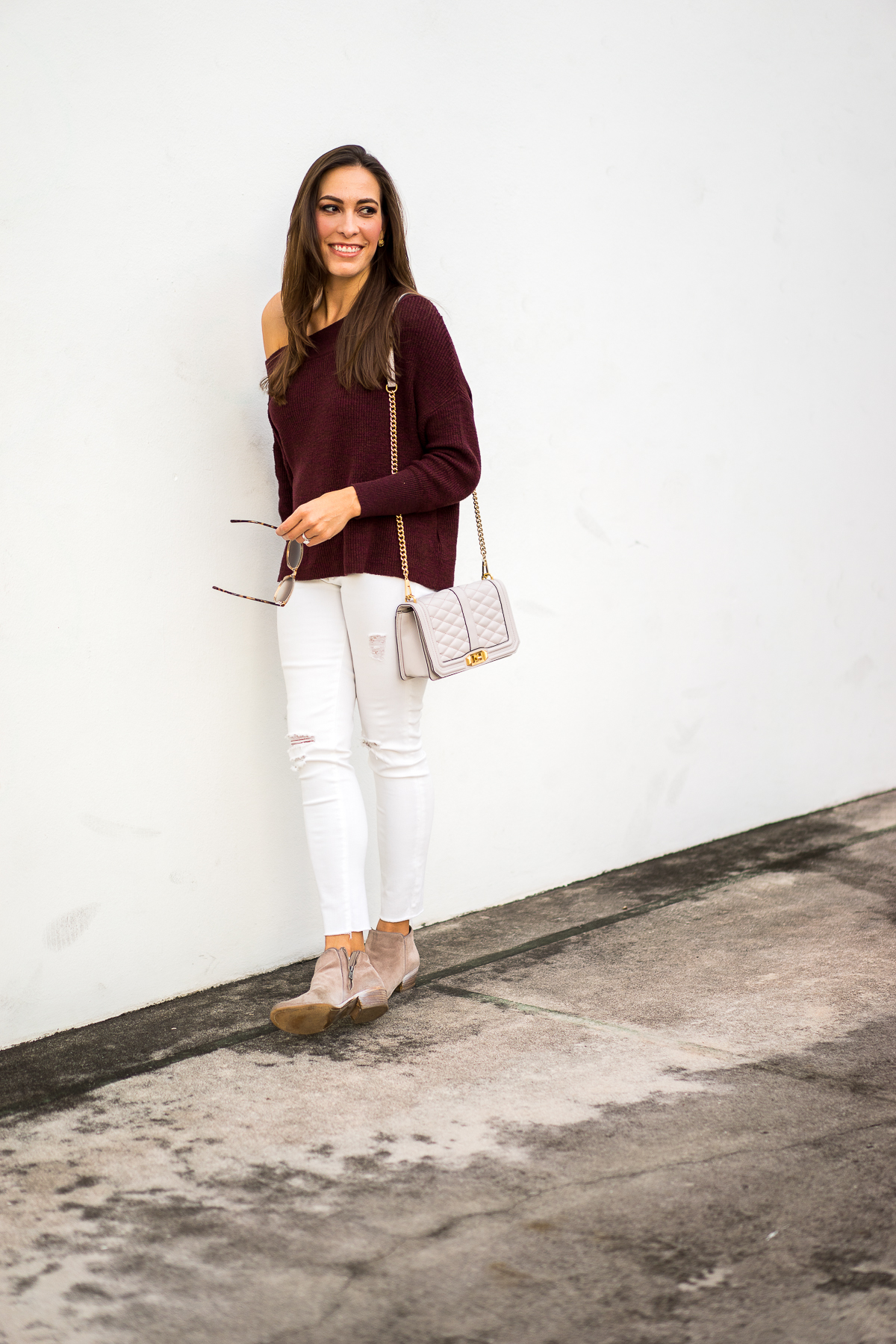 Best Luxury Designers Handbags blogger Amanda Mercado in fall fashion favorites including Free People Alana slouchy dolman sleeve sweater and taupe ankle booties