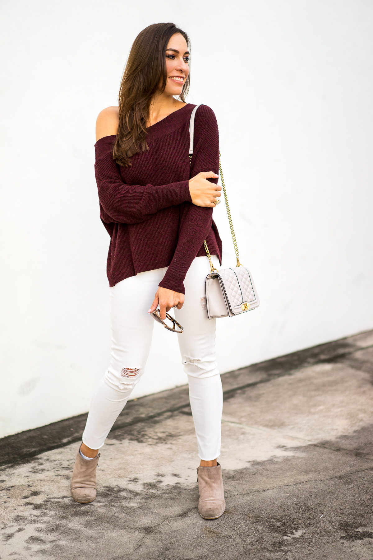 Best Luxury Designers Handbags fashion blogger wearing Free People slouchy sweater with dolman sleeves and Sam Edelman petty boots for fall fashion style