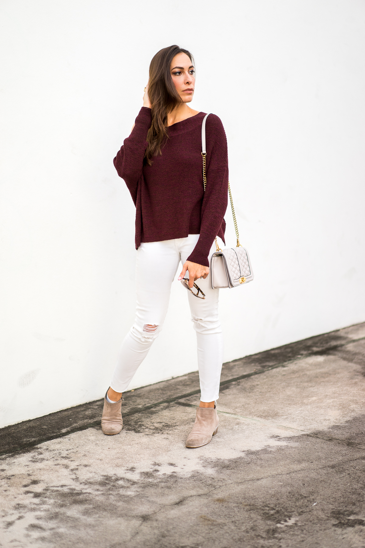Best Luxury Designers Handbags fashion blogger Amanda Mercado shows you how to wear falls trends including this burgundy off the shoulder sweater
