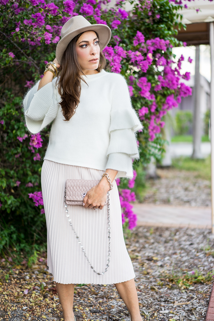 Best Luxury Designers Handbags fashion blogger wearing Endless Rose tiered sleeve sweater and blush pleated midi skirt with Miu Miu bag and white pumps