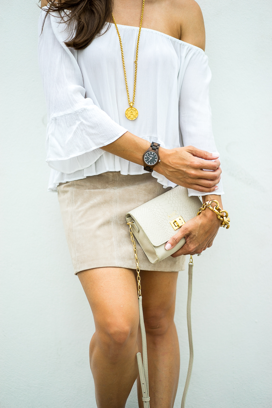 Best Luxury Designers Handbags Blogger Top Quality Luxury Handbag Shop shares JORD Wood Watch + Giveaway - in photo: Amanda wearing a white offshoulder top, brown skirt, and holding a clutch 