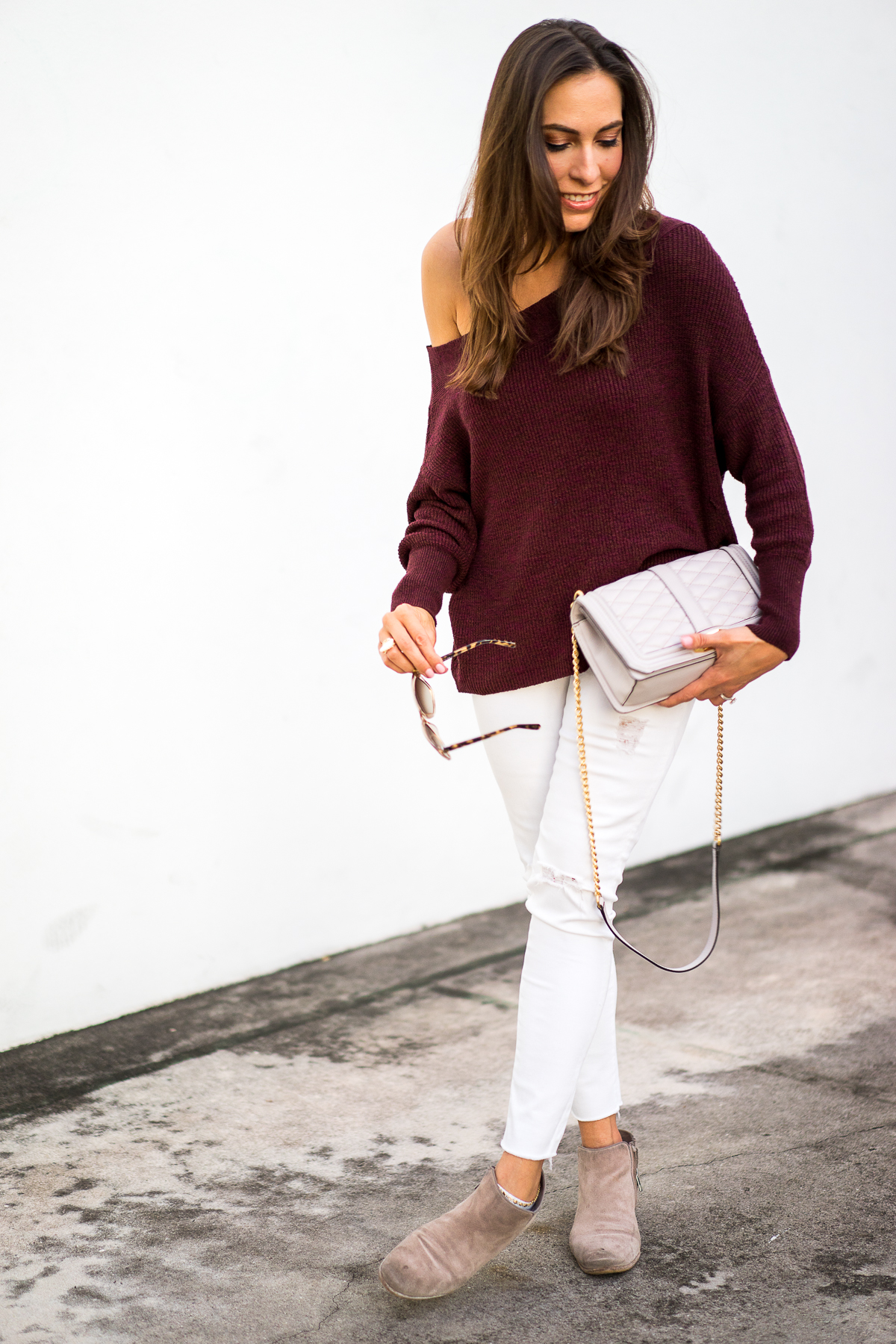 Best Luxury Designers Handbags blogger wearing fall fashion trends like this Free People slouchy dolman sleeve sweater in burgundy