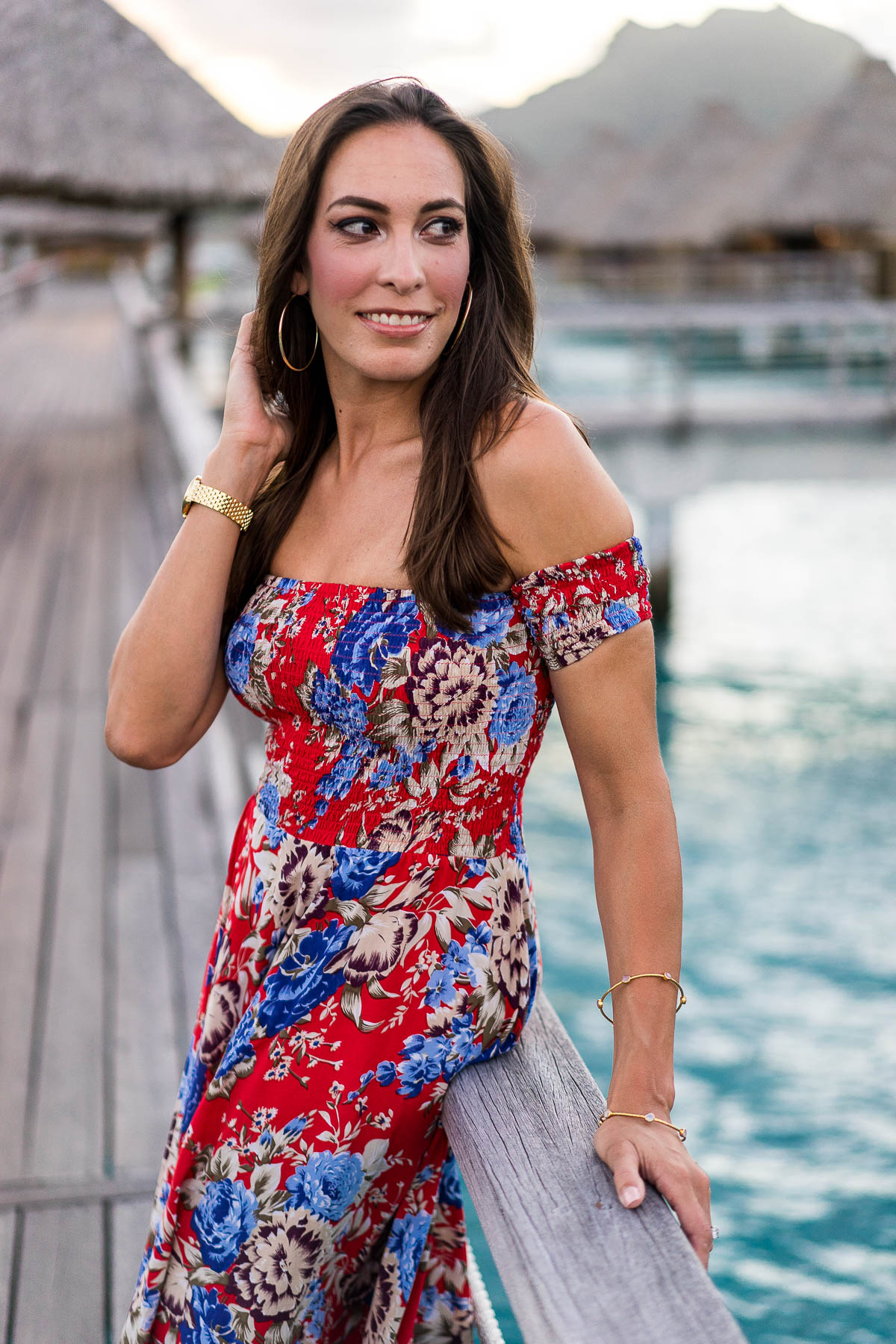 Best Luxury Designers Handbags fashion blogger watches sunset in Bora Bora wearing Auguste the Label floral maxi dress and tan bow sandals with gold jewelry