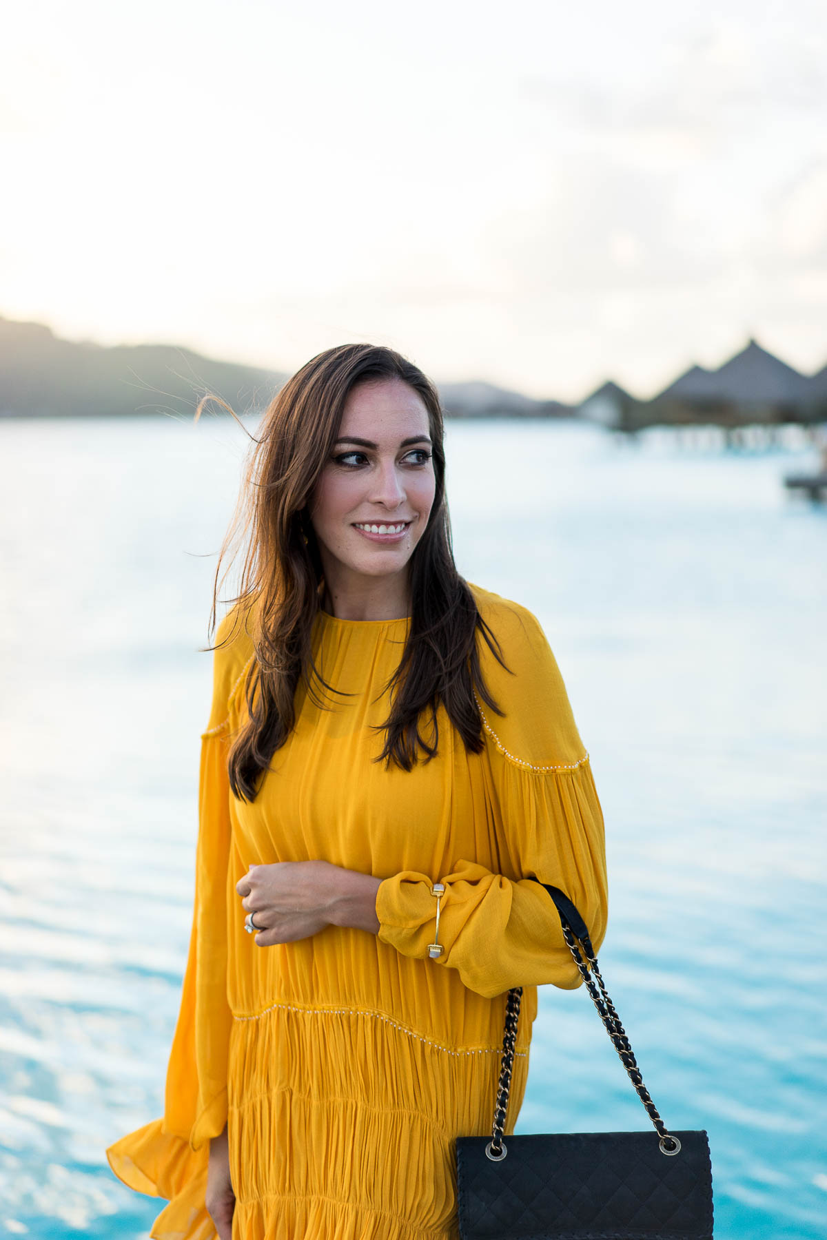 Amanda from Best Luxury Designers Handbags wears mustard yellow dress and classic Chanel bag on honeymoon