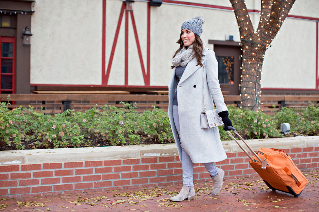 Amanda from Best Luxury Designers Handbags blog shares her favorite travel outfits and travel essentials like a Tumi Voyageur carry on bag