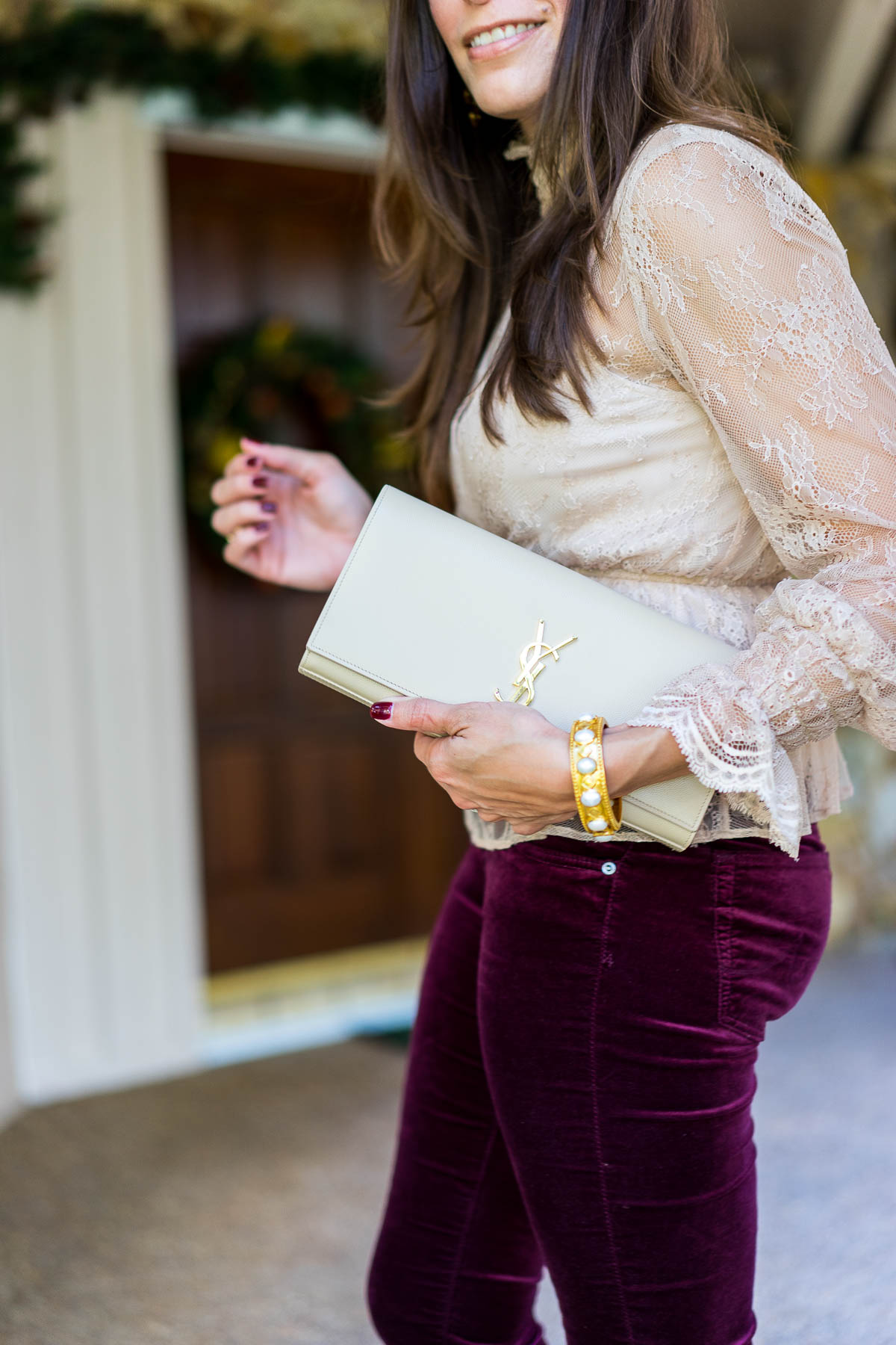 Best Luxury Designers Handbags blogger Amanda carries her YSL nude monogram clutch with her Christmas day outfit