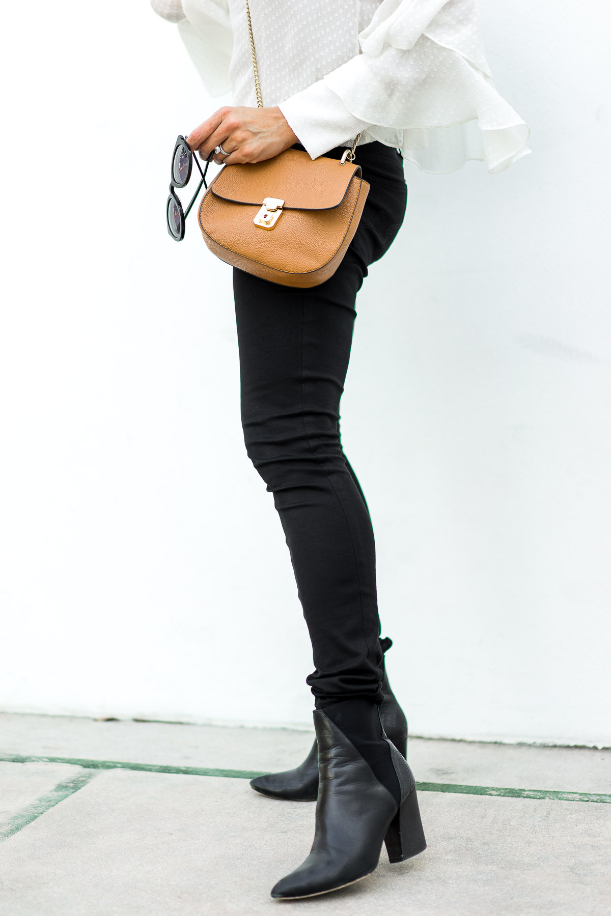 South Florida blogger Amanda from Best Luxury Designers Handbags wears her favorite black ASKA Troy booties with a gorgeous Olivia Palermo x Chelsea28 sheer white blouse while carrying a Chloe Drew bag dupe