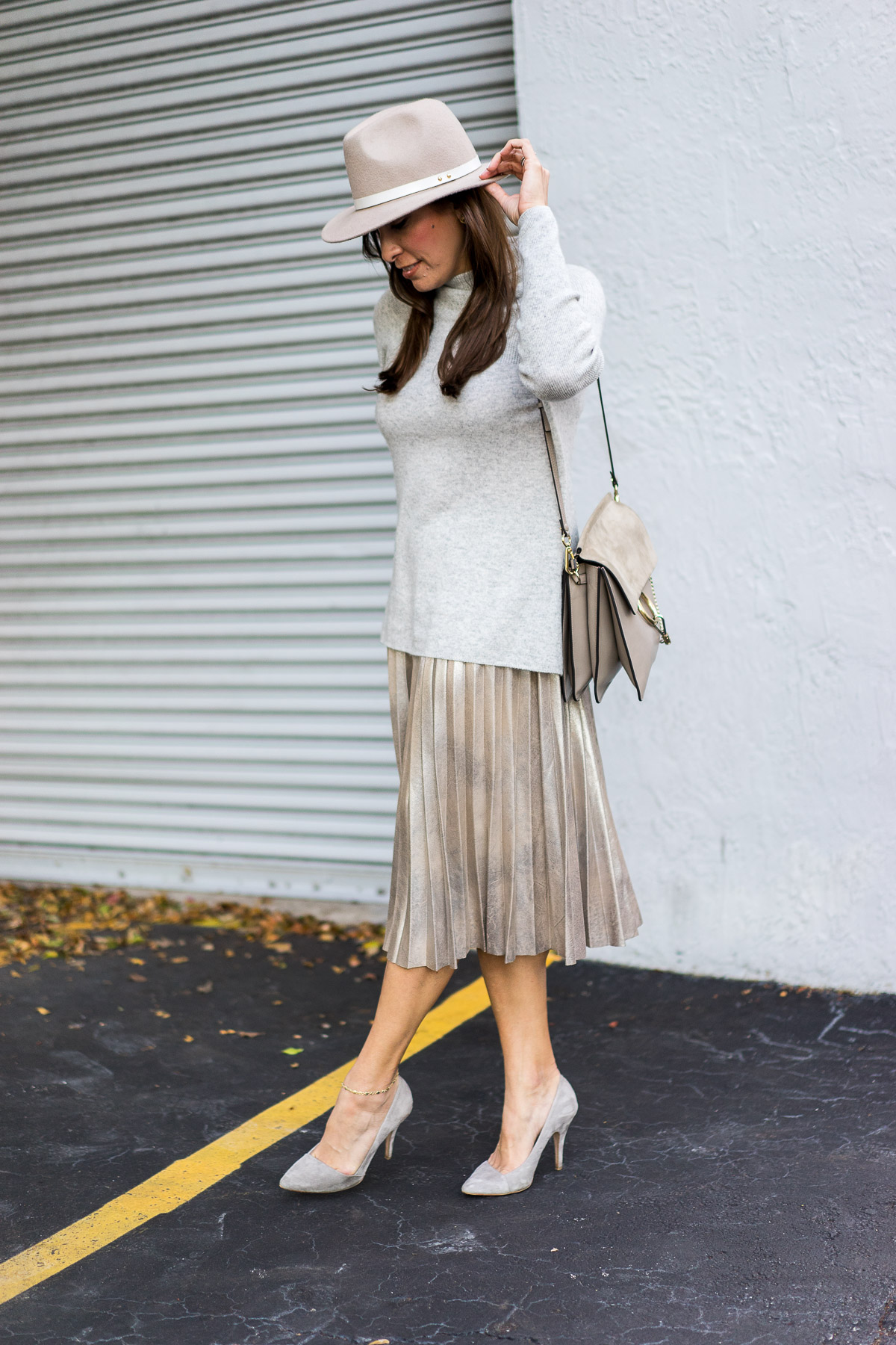 Best Luxury Designers Handbags blogger Amanda wears Zara gold metallic midi skirt with her grey cashmere sweater and Chloe Faye medium bag for Florida winter weather