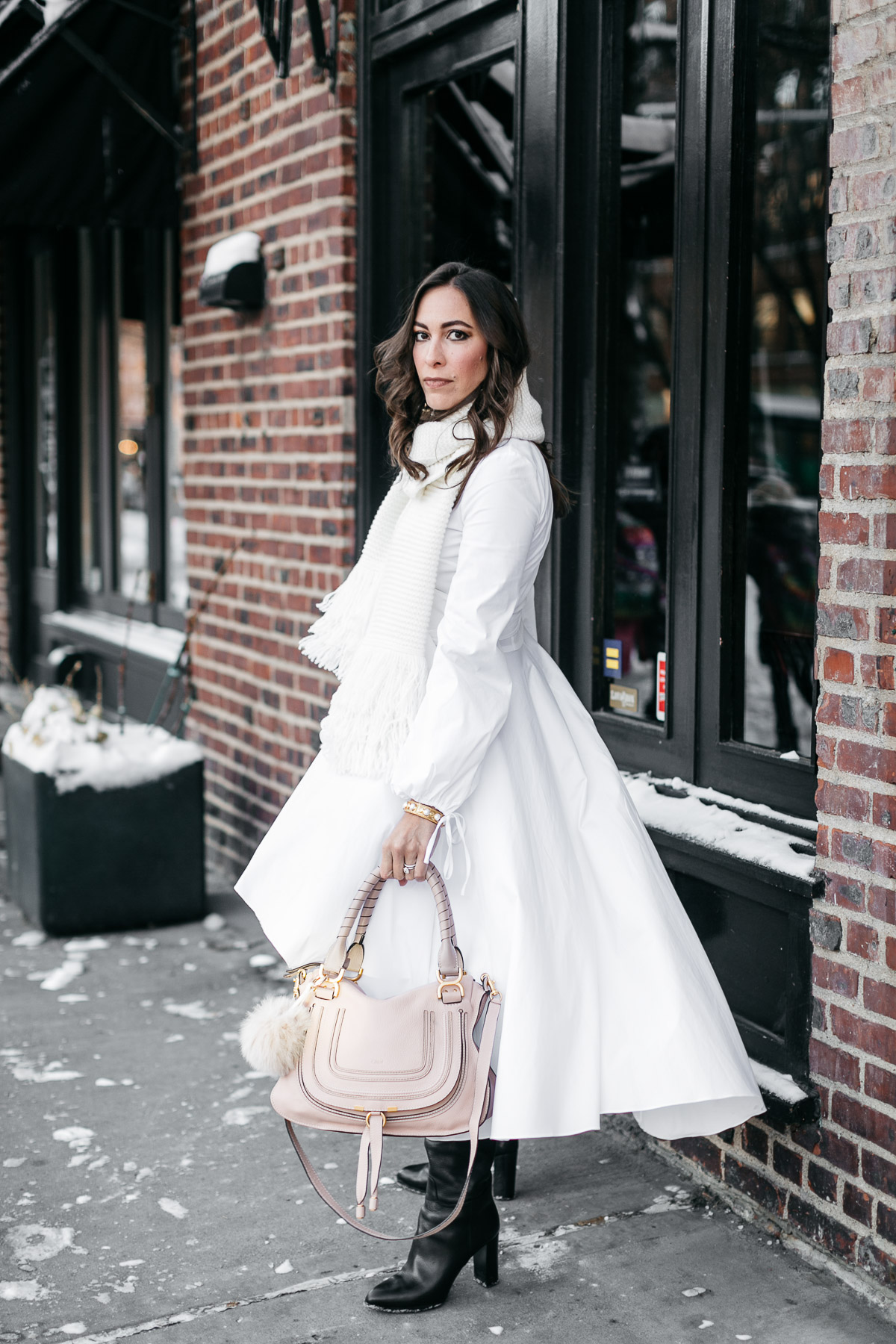 Amanda from Best Luxury Designers Handbags blog wears Carolina Constas Lena white shirt dress during NYFW Spring 2017 shows carrying her Chloe Marcie bag and accessorized with MGemi Pendolo black boots and Club Monaco Juki white fringed scarf