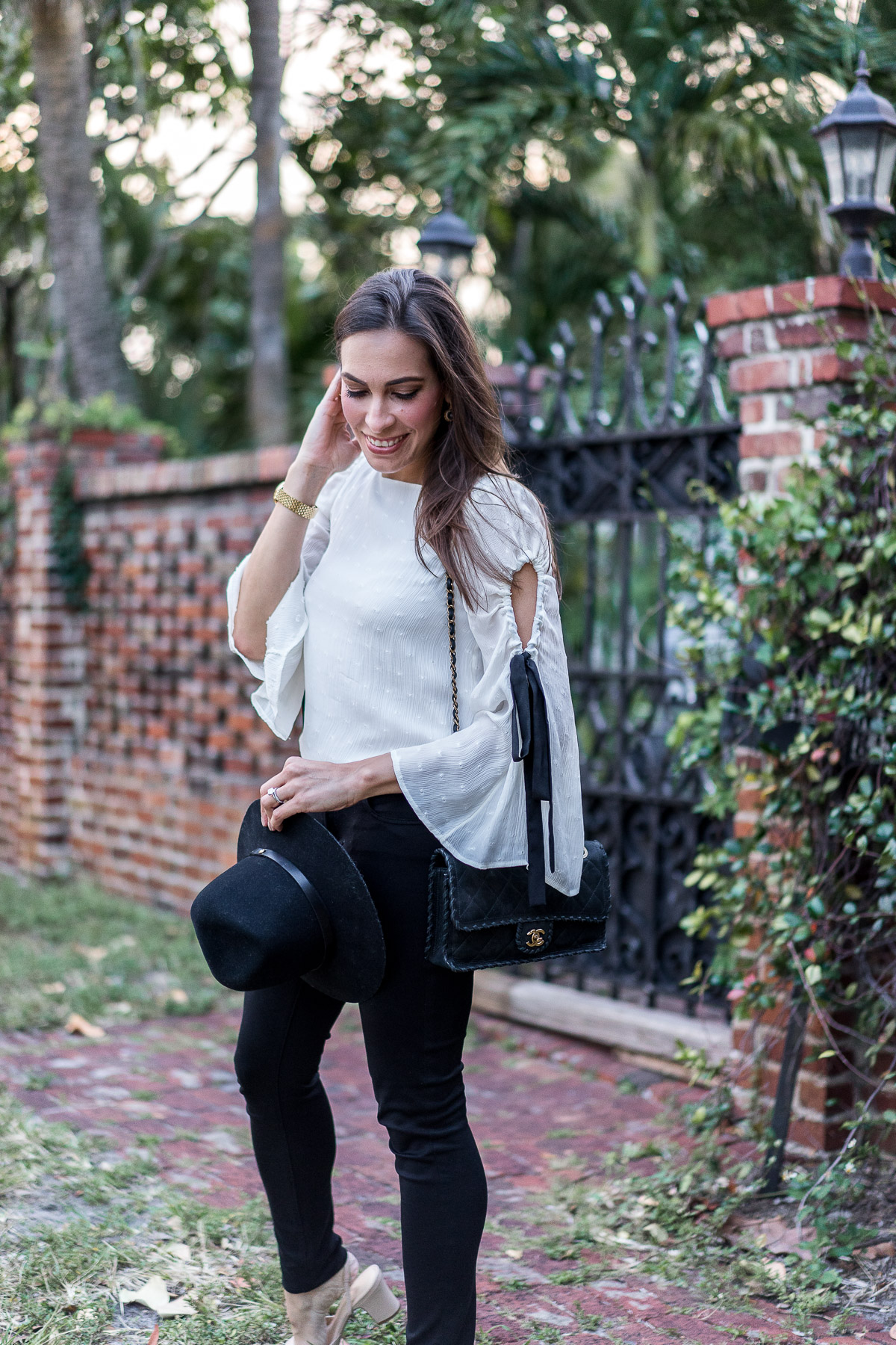 Amanda from Best Luxury Designers Handbags wears Club Monaco bell sleeve top with Rag and Bone fedora and easy black AG legging jeans