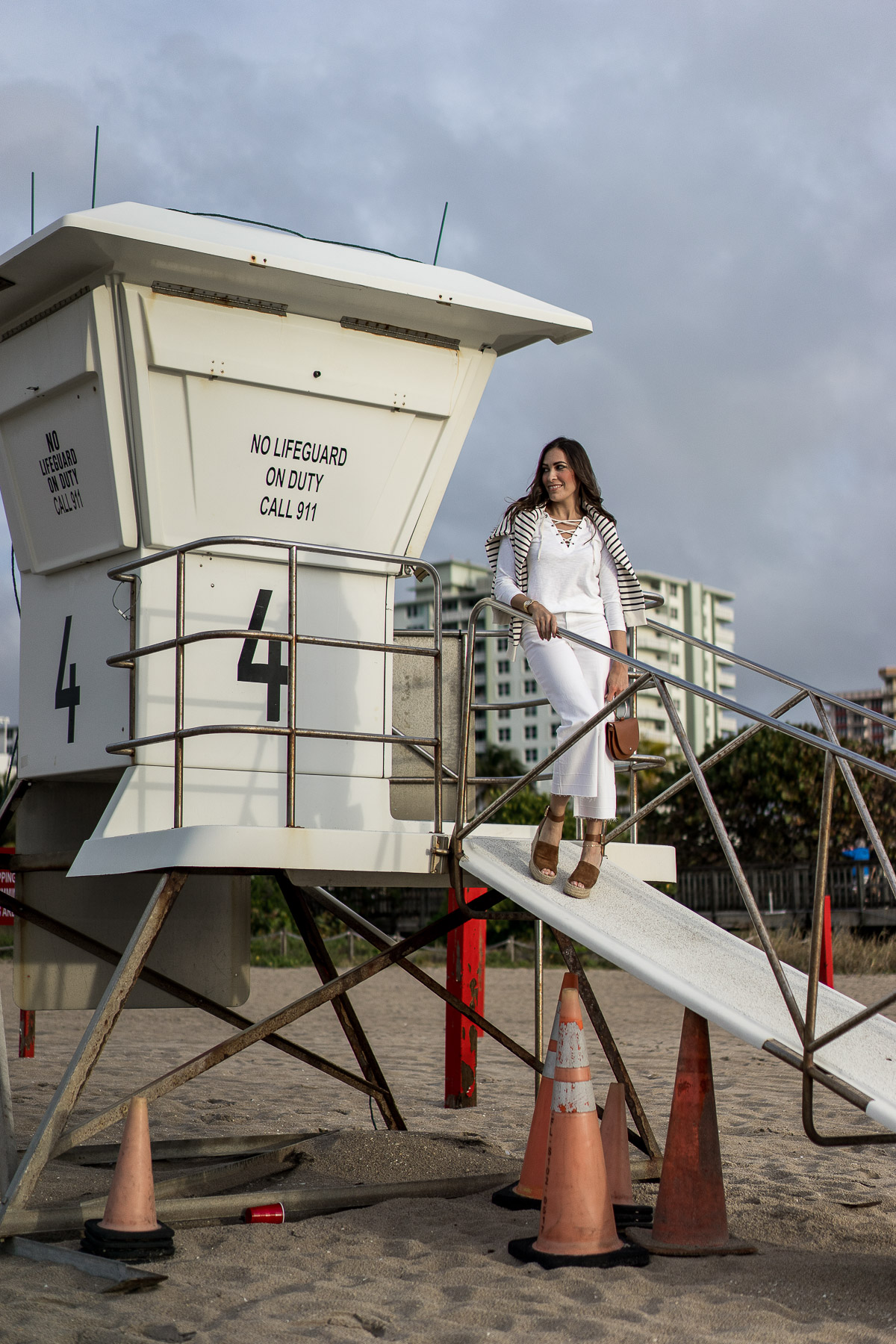 Best Luxury Designers Handbags blogger Amanda wears Old Navy striped sweatshirt with white lace up tee and high waist wide leg denim for a neo-nautical look