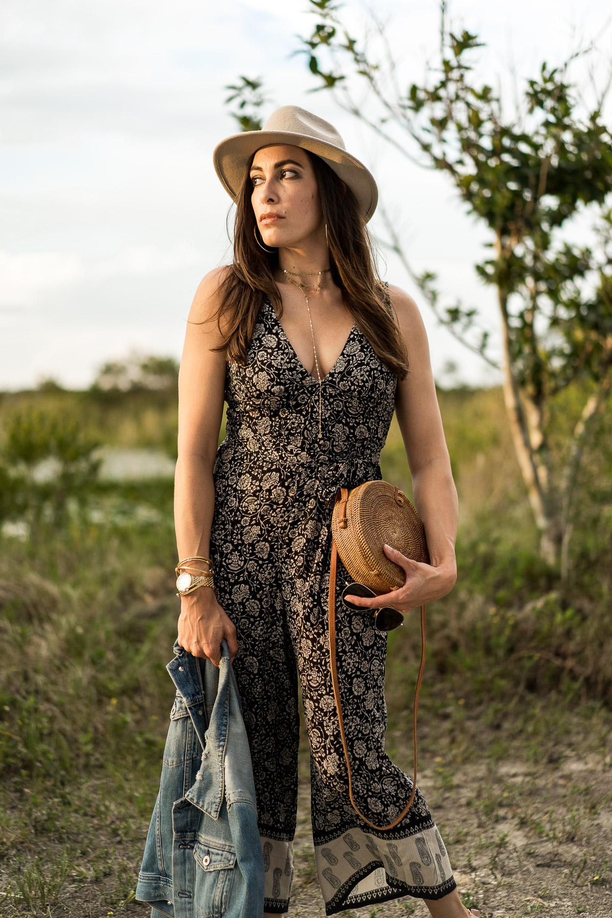 Summer boho style modeled by Amanda of Best Luxury Designers Handbags blog in an Amuse Society jumpsuit and round basket bag