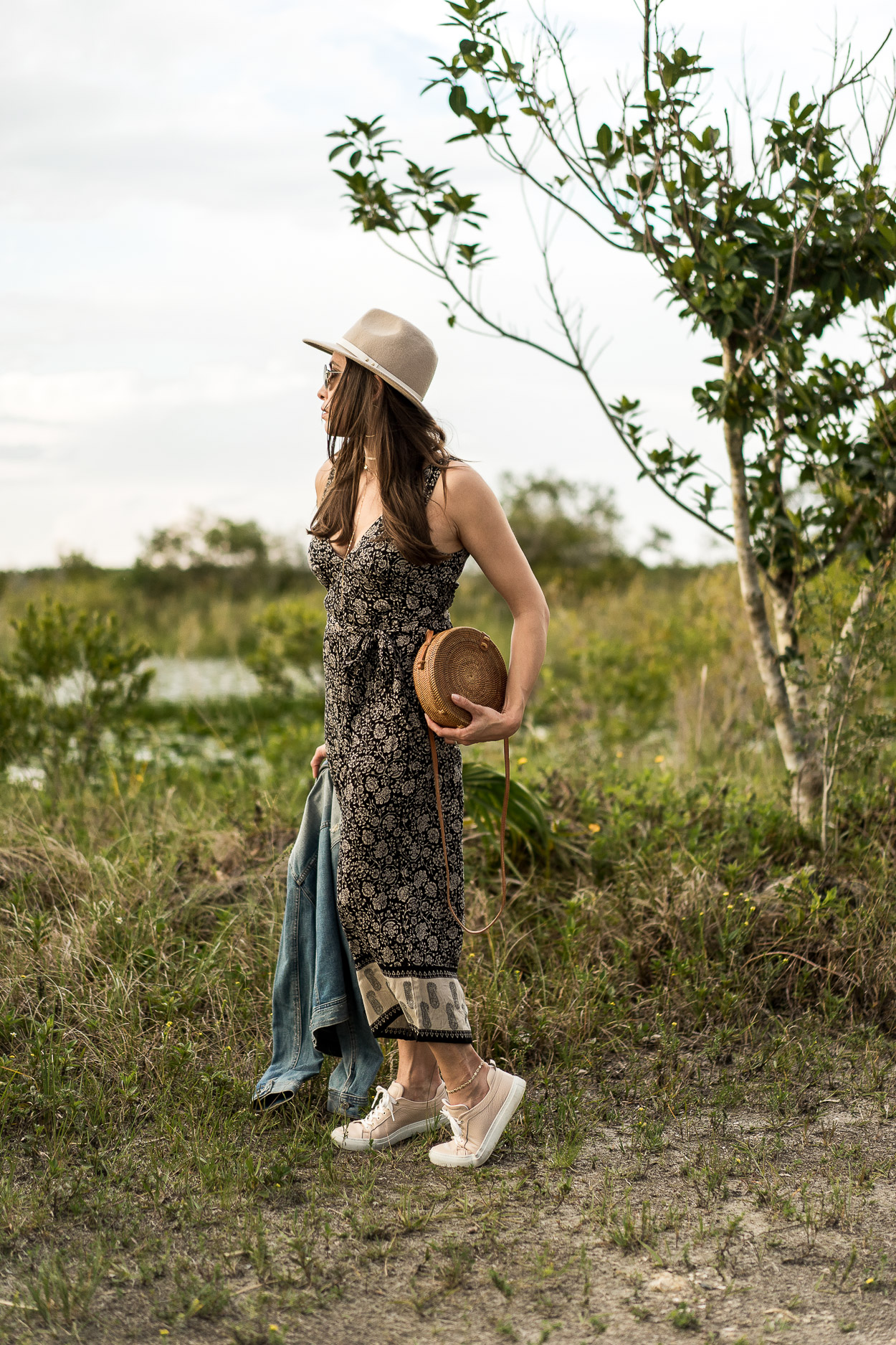 Boho style is so trendy for Summer like this Amuse Society jumpsuit Amanda of Best Luxury Designers Handbags blog wears with chic accessories like round basket bag and MGemi Palestra sneakers