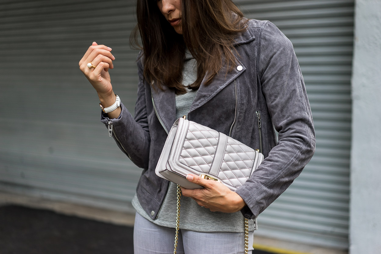 Best Luxury Designers Handbags Blogger Top Quality Luxury Handbag Shop in all grey outfit and holding her bag