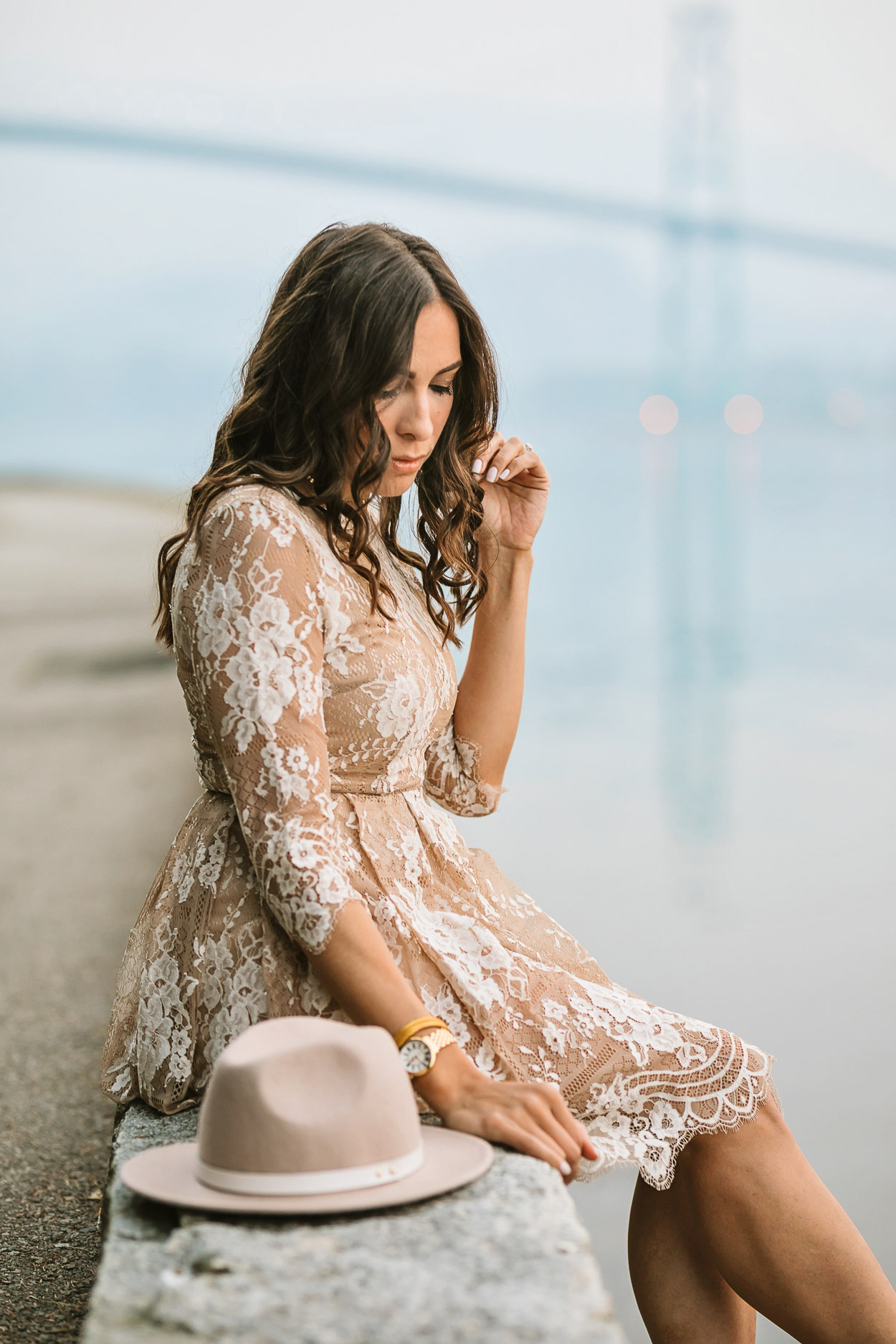 Blogger Amanda of Best Luxury Designers Handbags wears Chicwish lace dress at Lions Gate