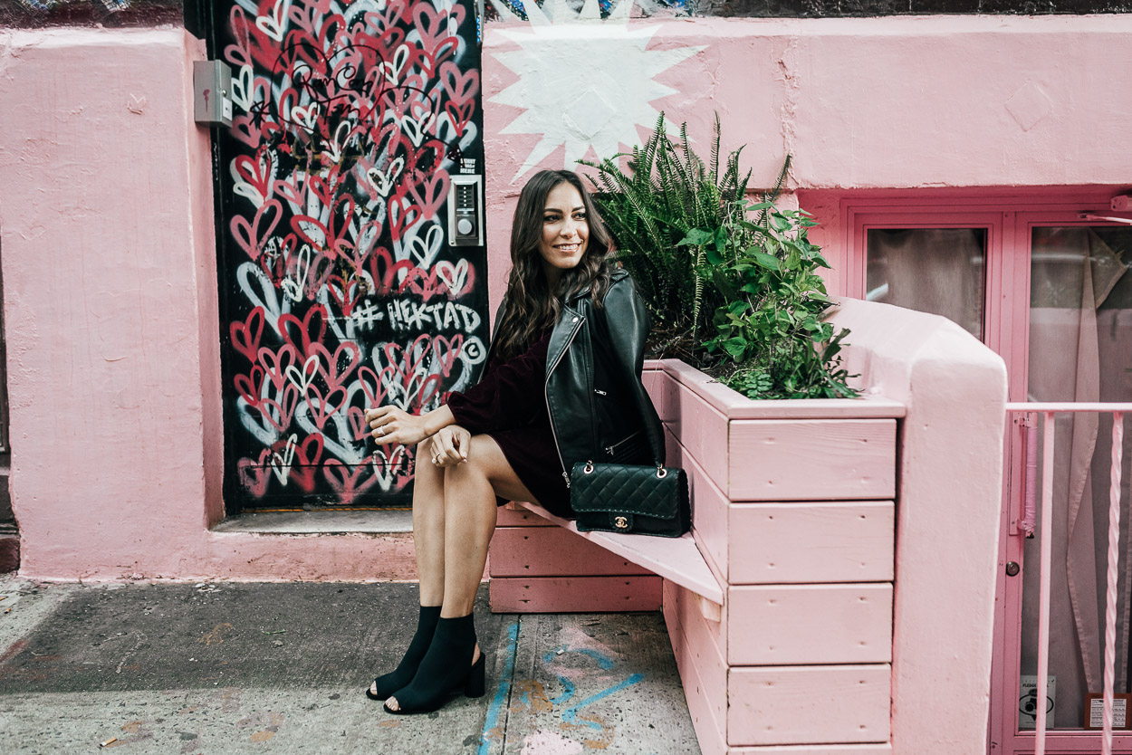 AGlamLifestyle blogger pairs velvet dress with black sock booties and Maje leather jacket for fall style
