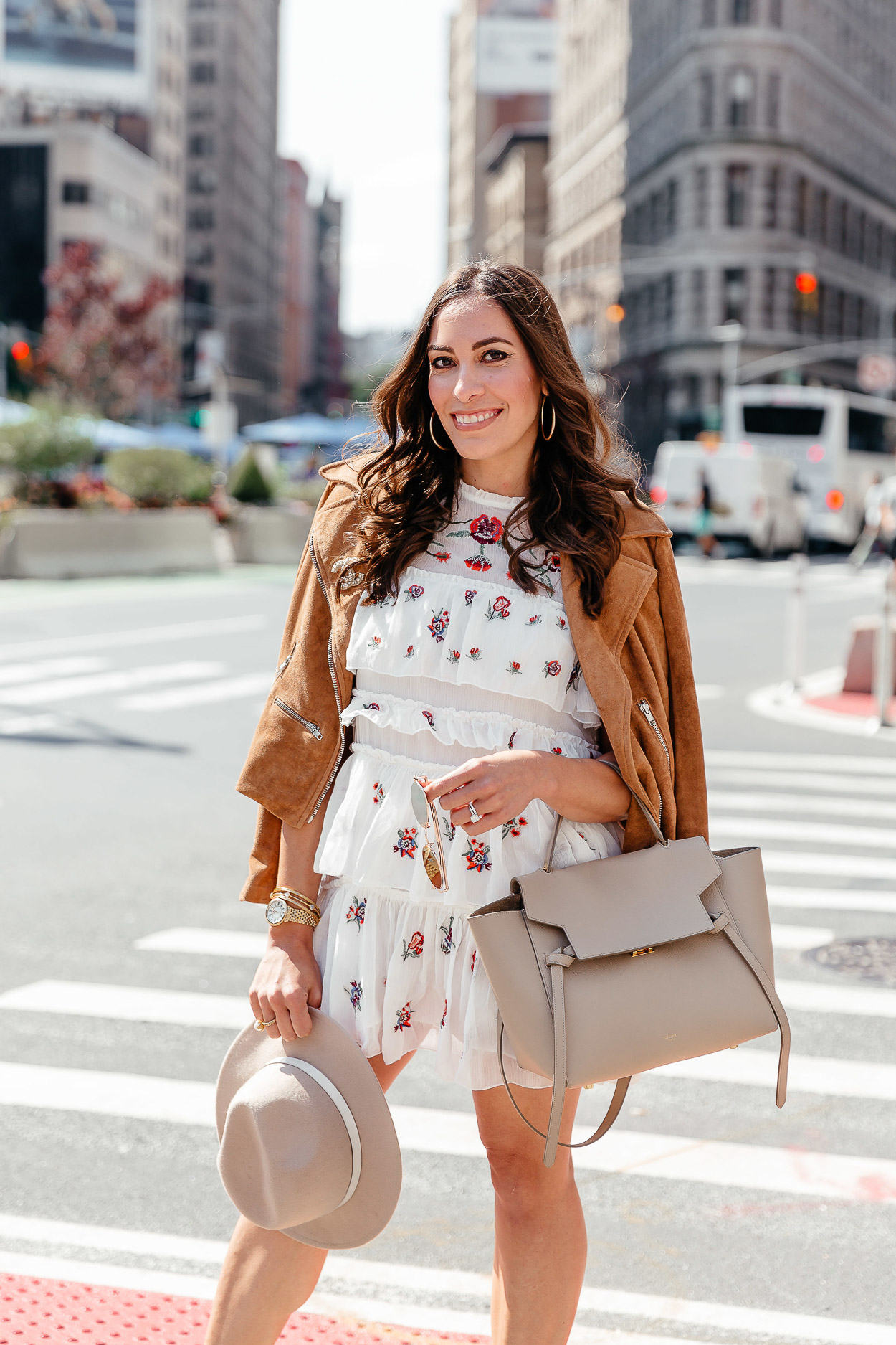 Best Luxury Designers Handbags blogger wears Chicwish tiered floral dress with white booties and Celine belt bag
