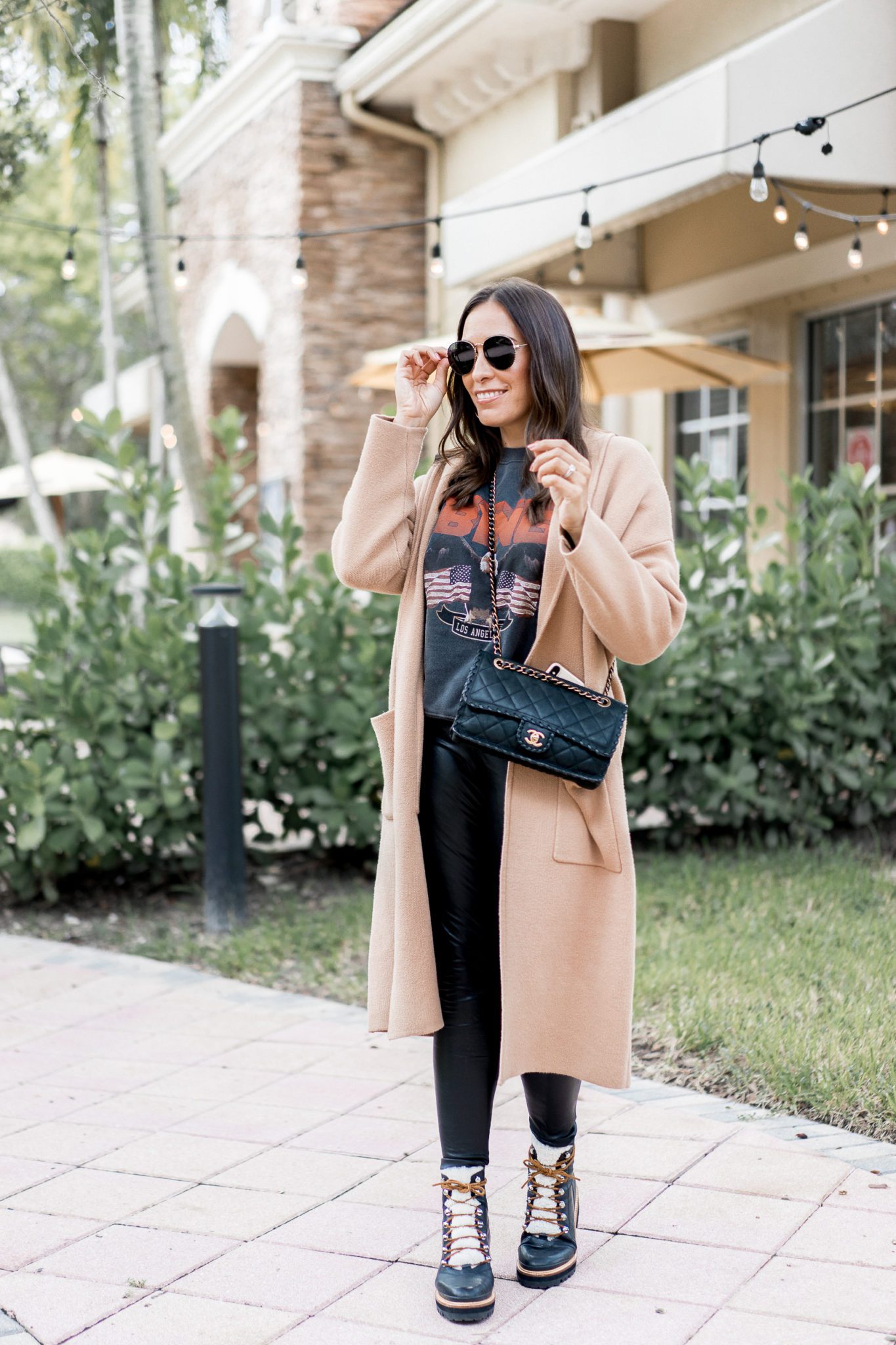 Top Florida fashion blogger Amanda of Best Luxury Designers Handbags wears an Anine Bing sweatshirt paired with Commando faux leather leggings for an easy fall outfit