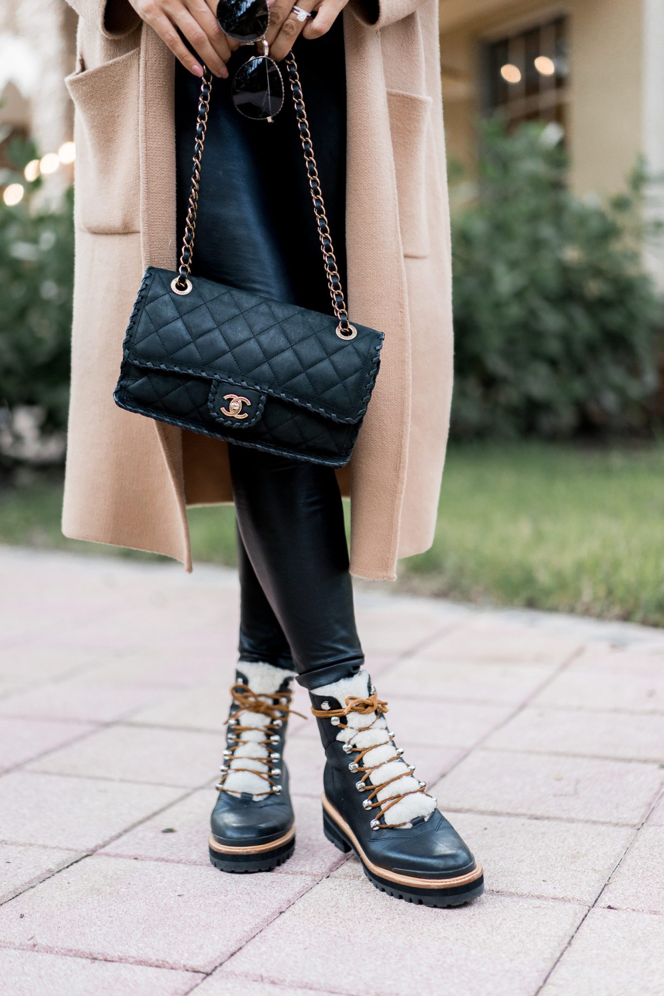 Top Florida fashion blogger Amanda of Best Luxury Designers Handbags wears an Anine Bing sweatshirt paired with Commando faux leather leggings for an easy fall outfit. These Marc Fisher Izzie boots sell out every year and look chic with an Anine Bing sweatshirt and faux leather leggings.